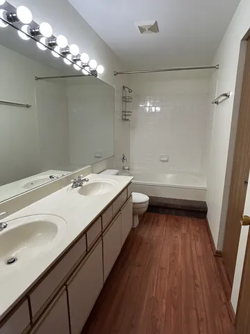 a bathroom with a double vanity sink and mirror