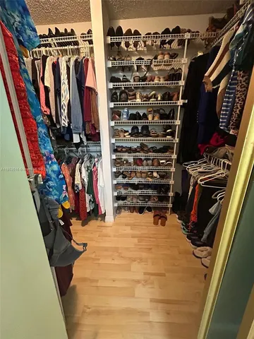 a white bath tub sitting next to a white toilet and vanity