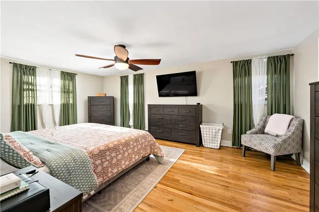 a bedroom with a bed and a television