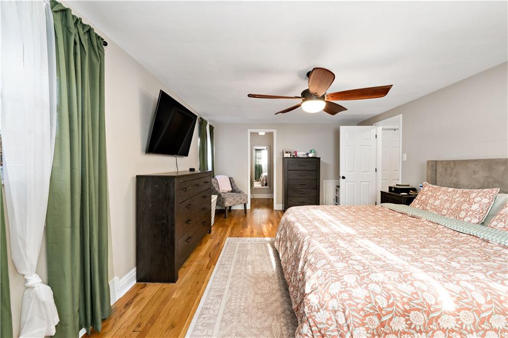 203 Washington Road Pittsburgh, PA 15221 - Photo 17 of 36 a spacious bedroom with a bed and a flat screen tv