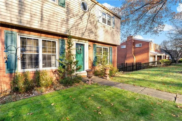 a view of a house with a yard and plants