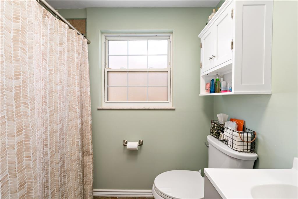 203 Washington Road Pittsburgh, PA 15221 - Photo 22 of 36 a white toilet sitting next to a bathroom sink and vanity