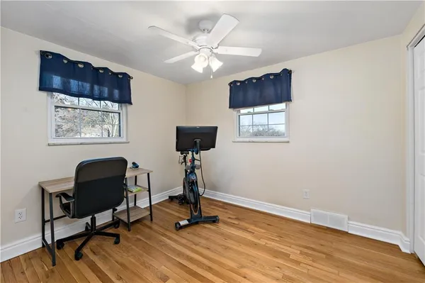 a view of a workspace with furniture and a window