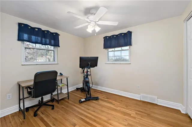 a view of a workspace with furniture and a window