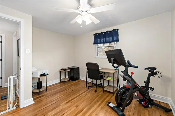 a view of a workspace with furniture and wooden floor