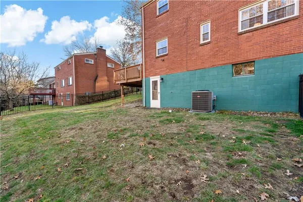 a backyard of a house with wooden fence