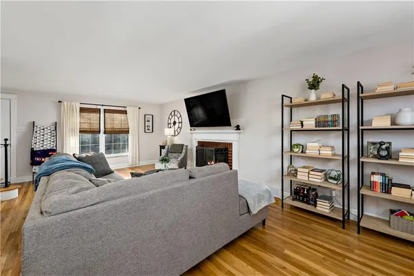 a living room with furniture a flat screen tv and a fireplace