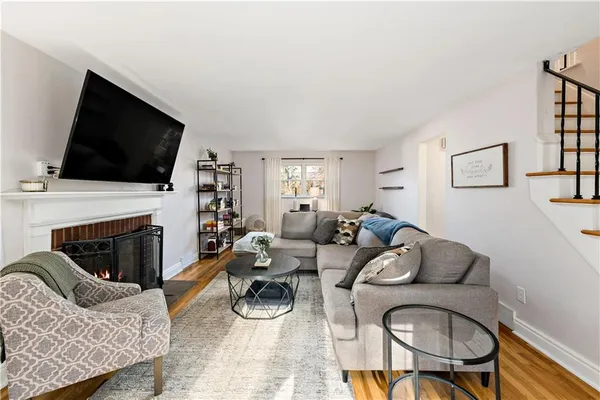a living room with furniture a fireplace and a flat screen tv