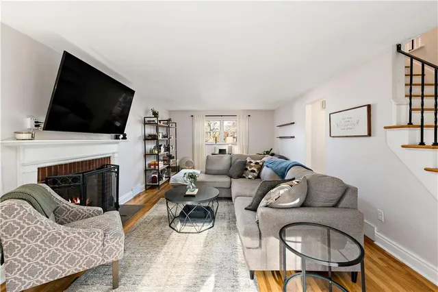 a living room with furniture a fireplace and a flat screen tv