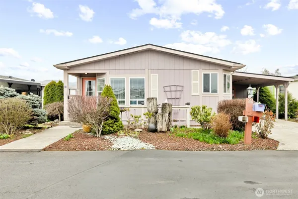 a front view of house with yard outdoor seating and barbeque oven