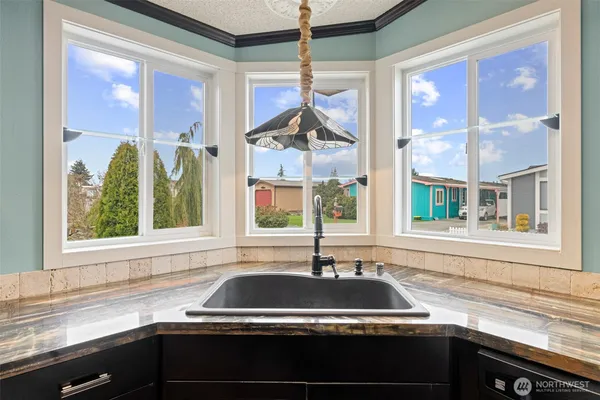 a kitchen with a sink and a large window