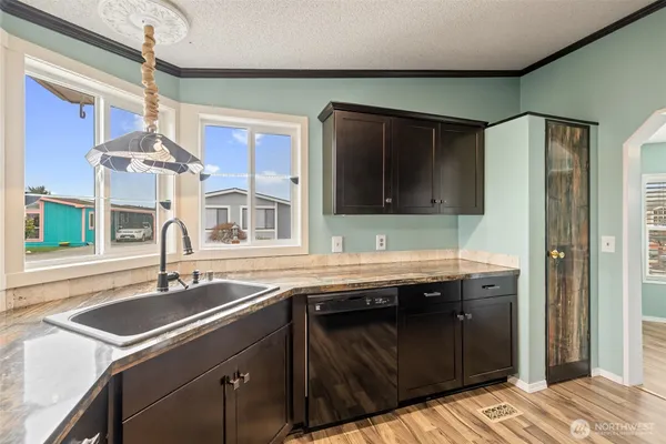 a kitchen with a sink and a refrigerator
