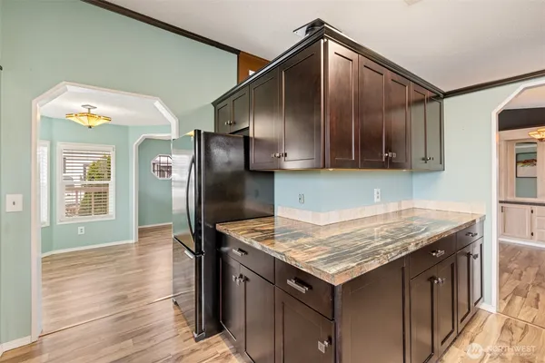 a kitchen with granite countertop a oven a refrigerator and a sink