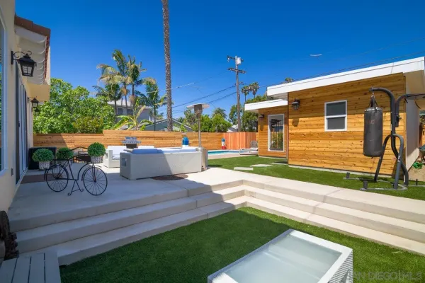 a view of a backyard with sitting area