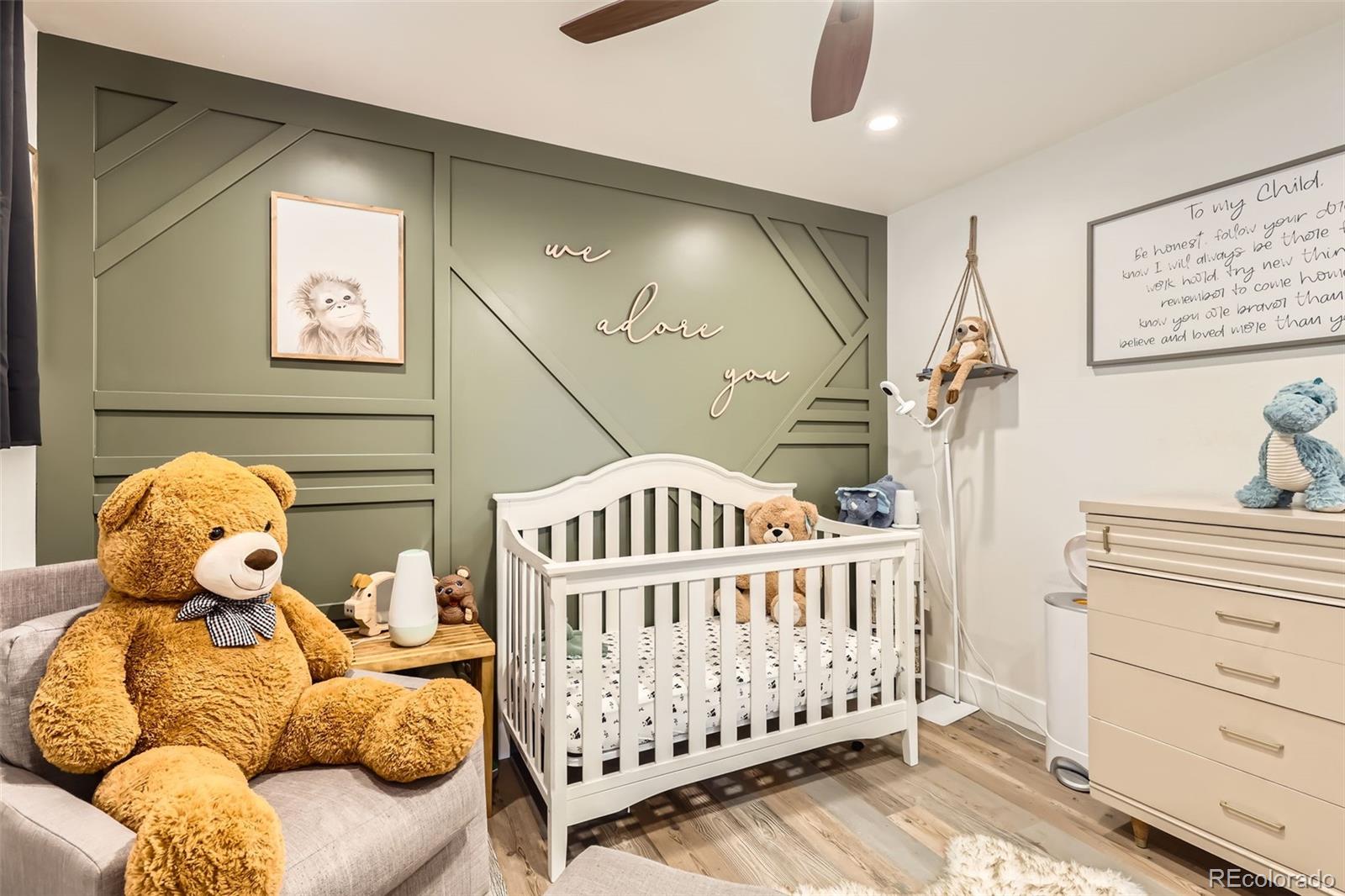 7120 Galapago Street Denver, CO 80221 - Photo 16 of 30 a bedroom with furniture and wooden floor