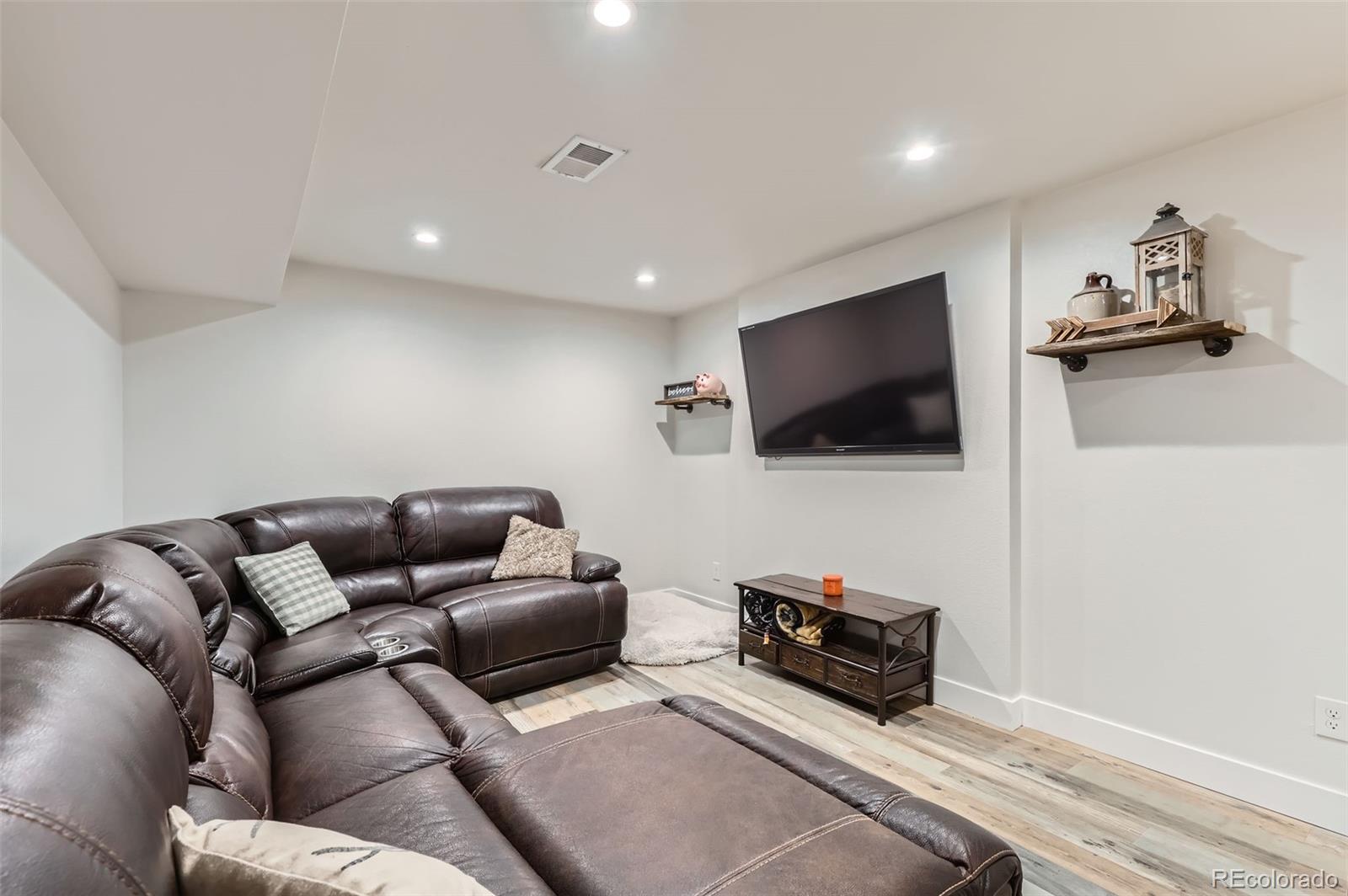 7120 Galapago Street Denver, CO 80221 - Photo 17 of 30 a living room with furniture and a flat screen tv