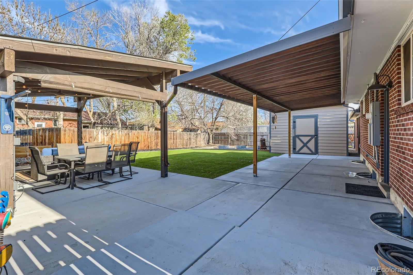 7120 Galapago Street Denver, CO 80221 - Photo 24 of 30 a view of a porch with chairs and backyard