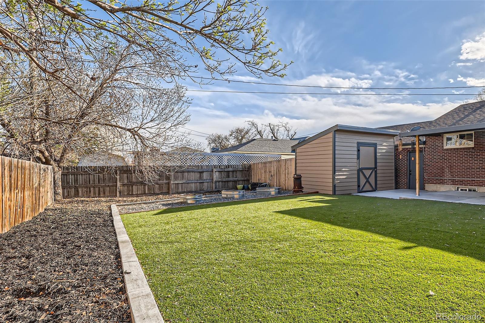 7120 Galapago Street Denver, CO 80221 - Photo 27 of 30 a swimming pool with outdoor seating and yard