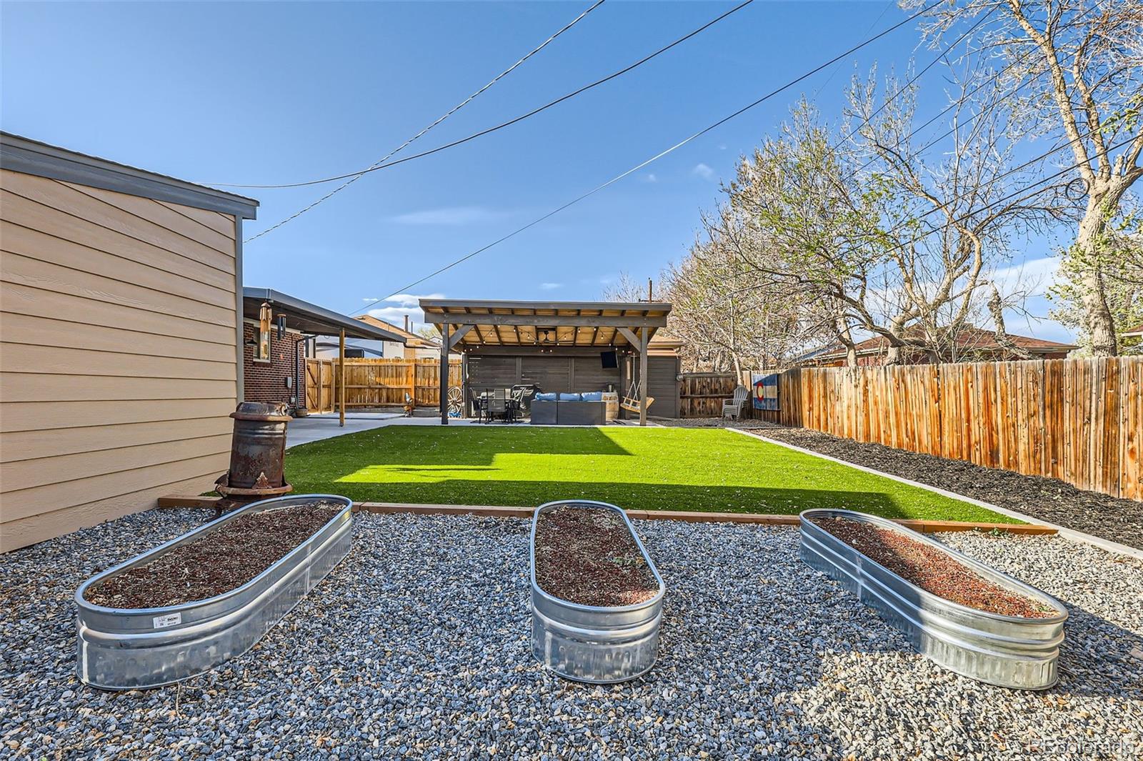 7120 Galapago Street Denver, CO 80221 - Photo 28 of 30 a backyard of a house with garden and outdoor seating