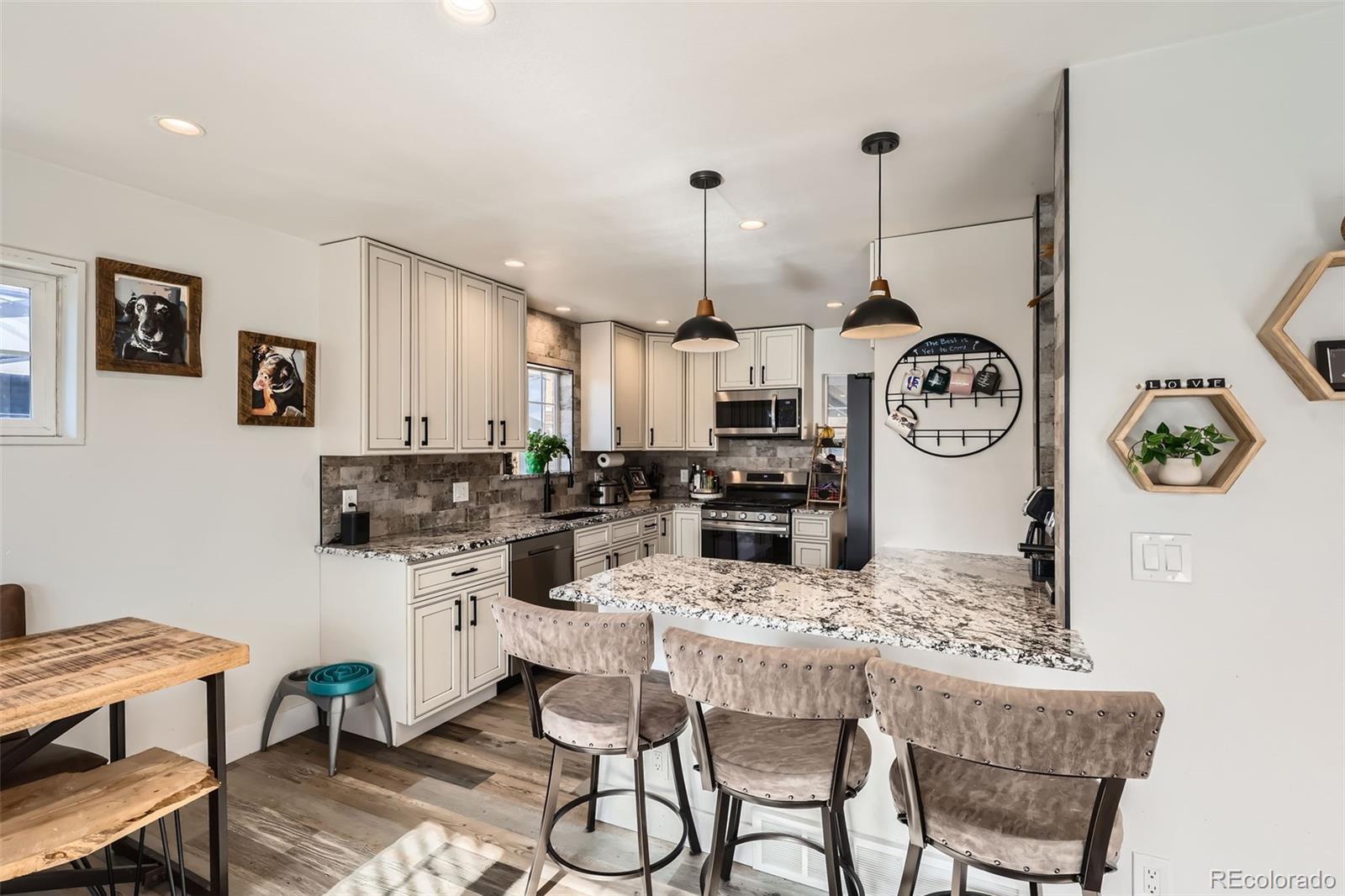 7120 Galapago Street Denver, CO 80221 - Photo 8 of 30 a dining room with chairs and kitchen view