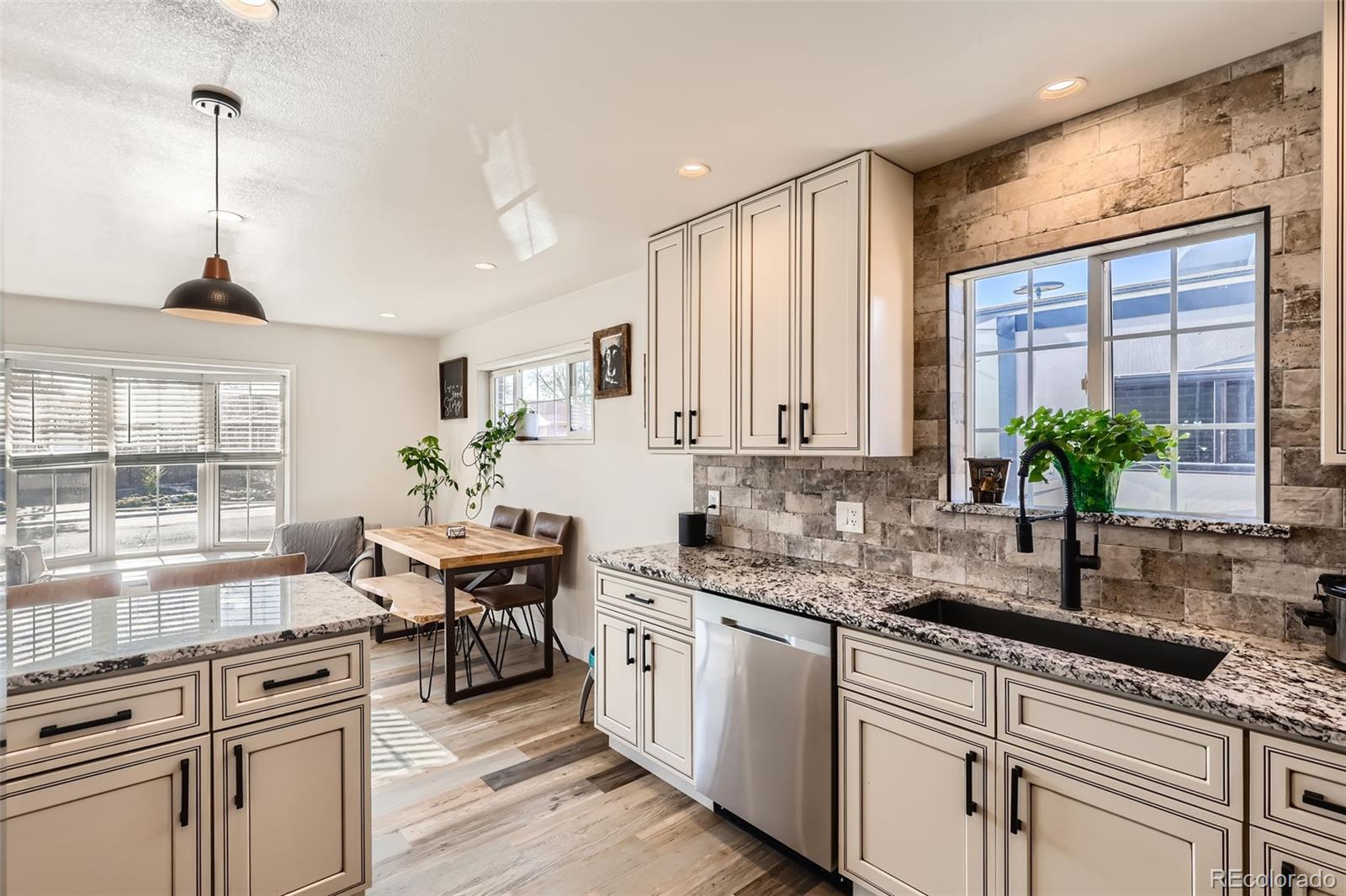 7120 Galapago Street Denver, CO 80221 - Photo 10 of 30 a kitchen with a sink stove and cabinets