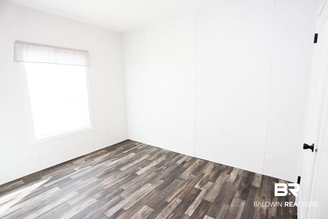 19180 Horseshoe Circle Seminole, AL 36574 - Photo 21 of 38 Spare room featuring dark wood-style floors