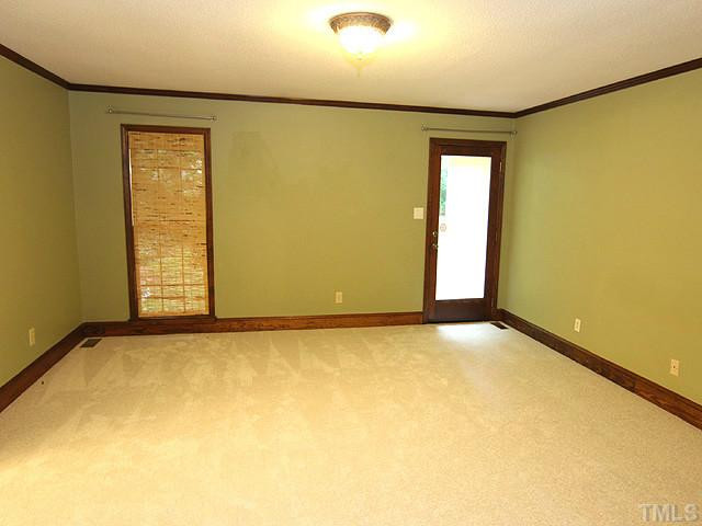 2215 Yorkgate Drive Raleigh, NC 27612 - Photo 10 of 24 The master bedroom is huge with a window and a door to the deck. Master Bedroom