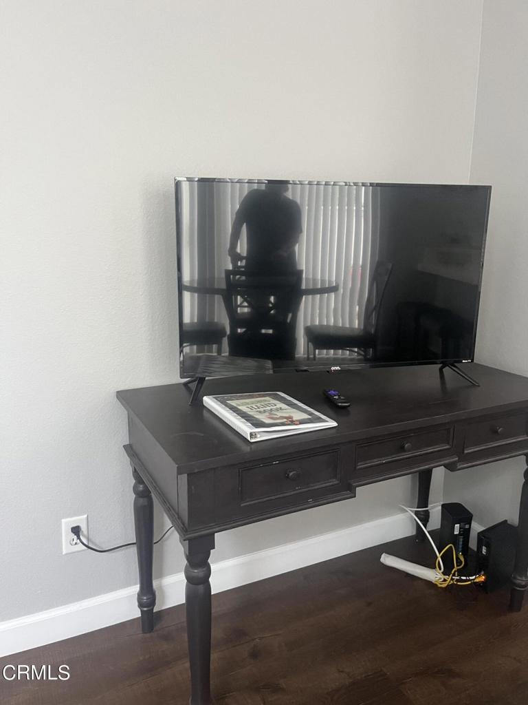 1027 Corte Primavera Oxnard, CA 93030 - Photo 13 of 23 a living room with a table chairs and a piano