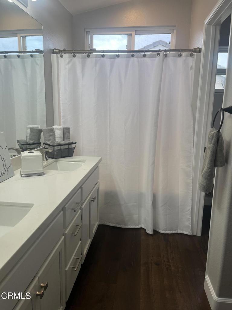 1027 Corte Primavera Oxnard, CA 93030 - Photo 14 of 23 a bathroom with a double vanity sink and a mirror
