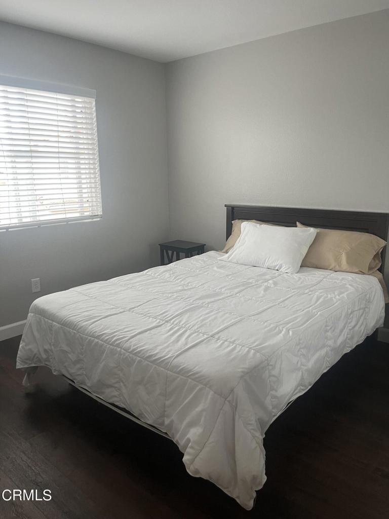1027 Corte Primavera Oxnard, CA 93030 - Photo 17 of 23 a bedroom with a bed and window