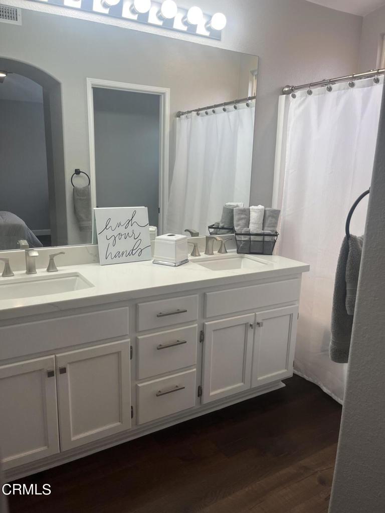 1027 Corte Primavera Oxnard, CA 93030 - Photo 18 of 23 a bathroom with a double vanity sink and a mirror