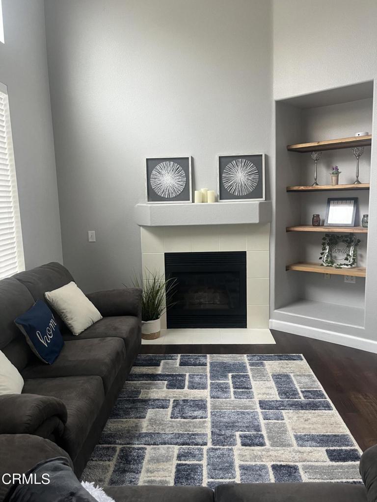 1027 Corte Primavera Oxnard, CA 93030 - Photo 8 of 23 a living room with furniture and a fireplace