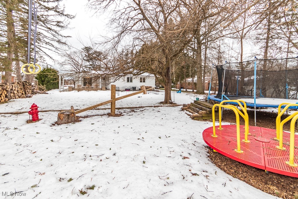 38856 Johnnycake Ridge Road Willoughby, OH 44094 - Photo 45 of 49 Yard covered in snow featuring a trampoline