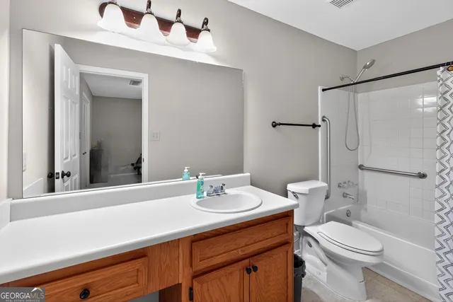 a spacious bedroom with a bed and a desk