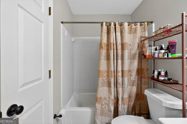 a view of a houses with a street from a balcony