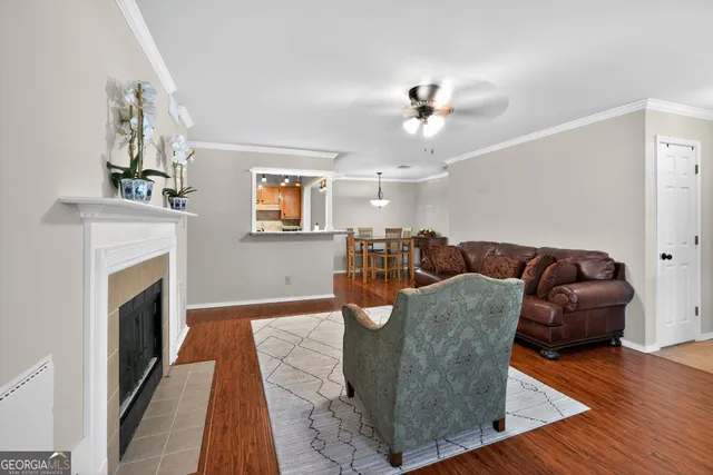 a living room with furniture a fireplace and wooden floor