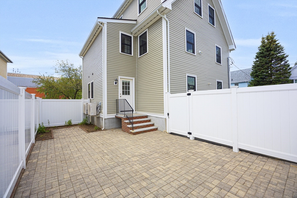 48 Spruce Street, Unit 1 Winchester, MA 01890 - Photo 26 of 29 a view of a house with backyard and sitting area