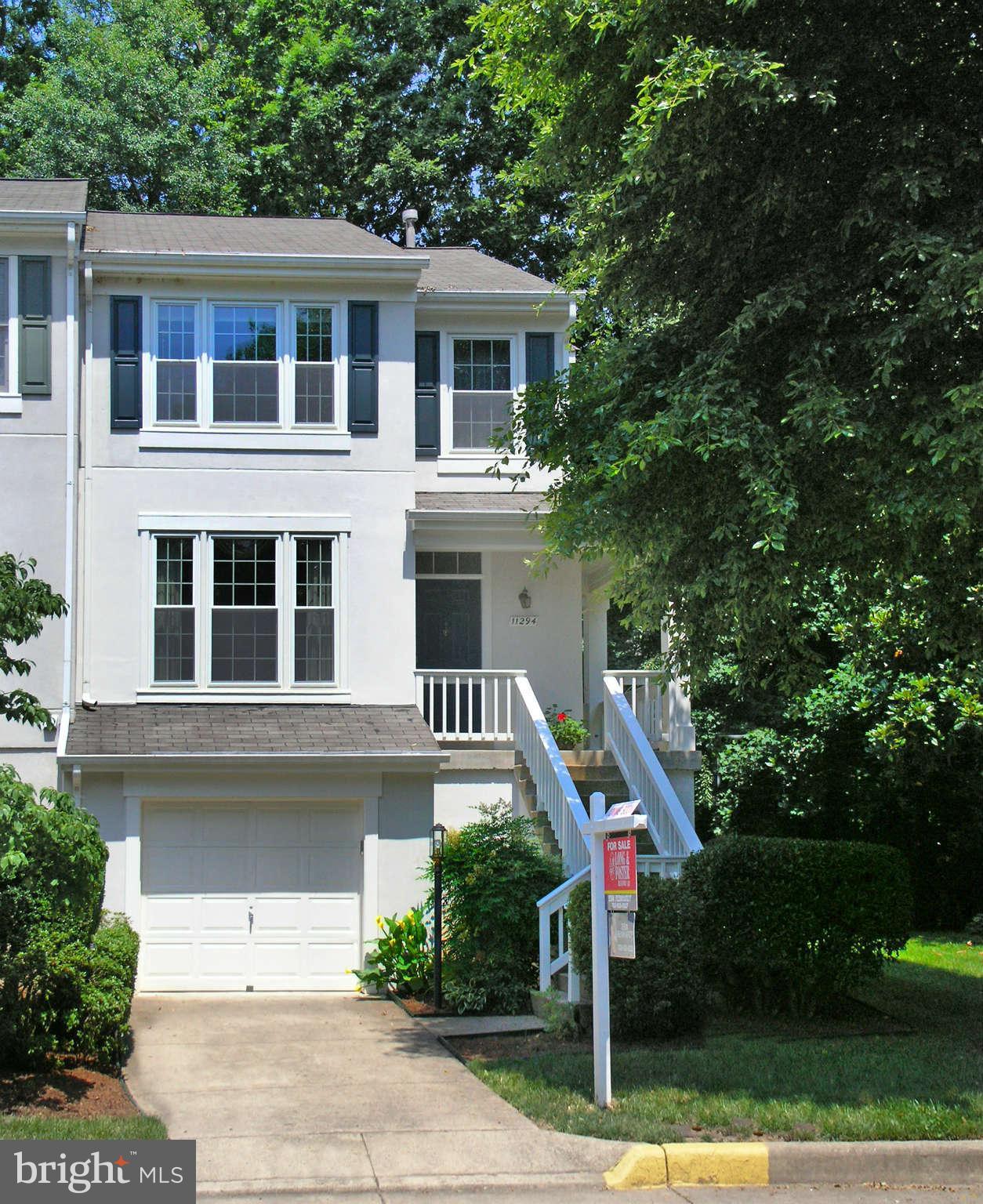 11294 Fairwind Way Reston, VA 20190 - Photo 1 of 30 a front view of a house with a yard and trees