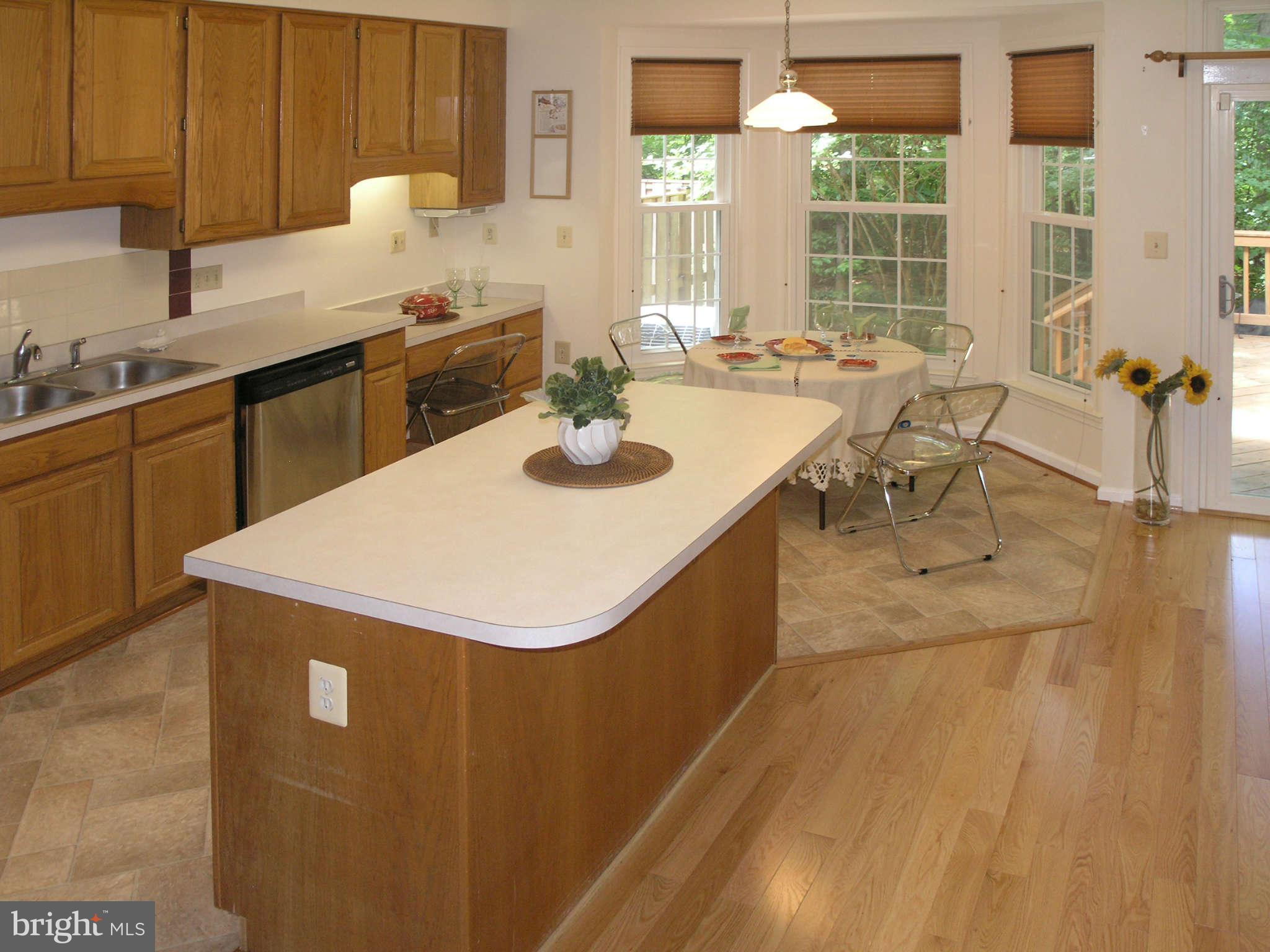 11294 Fairwind Way Reston, VA 20190 - Photo 13 of 30 a kitchen with a sink a stove and chairs