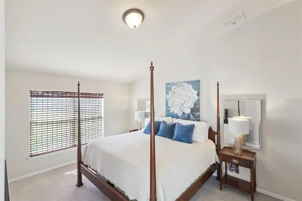 a bedroom with a bed and a window