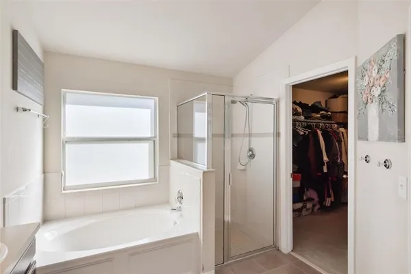 a bathroom with a bathtub and a shower