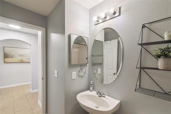 a bathroom with a sink mirror and vanity