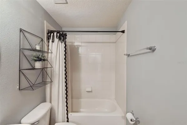 a bathroom with a shower and a toilet