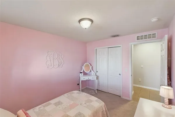 a bedroom with a bed and a desk