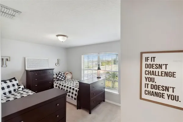 a bedroom with a bed and a dresser in it