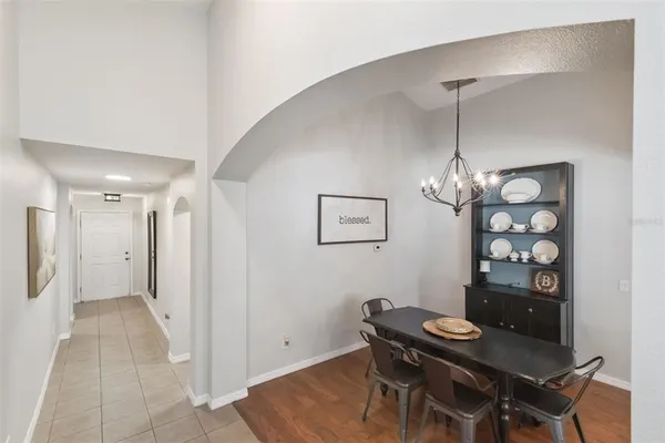 a view of a dining room with furniture and chandelier