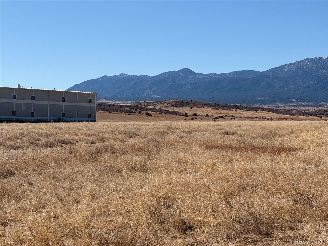 168 East Routt Street Colorado City, CO 81019 - Photo 7 of 7 a view of a dry field with mountains in the background
