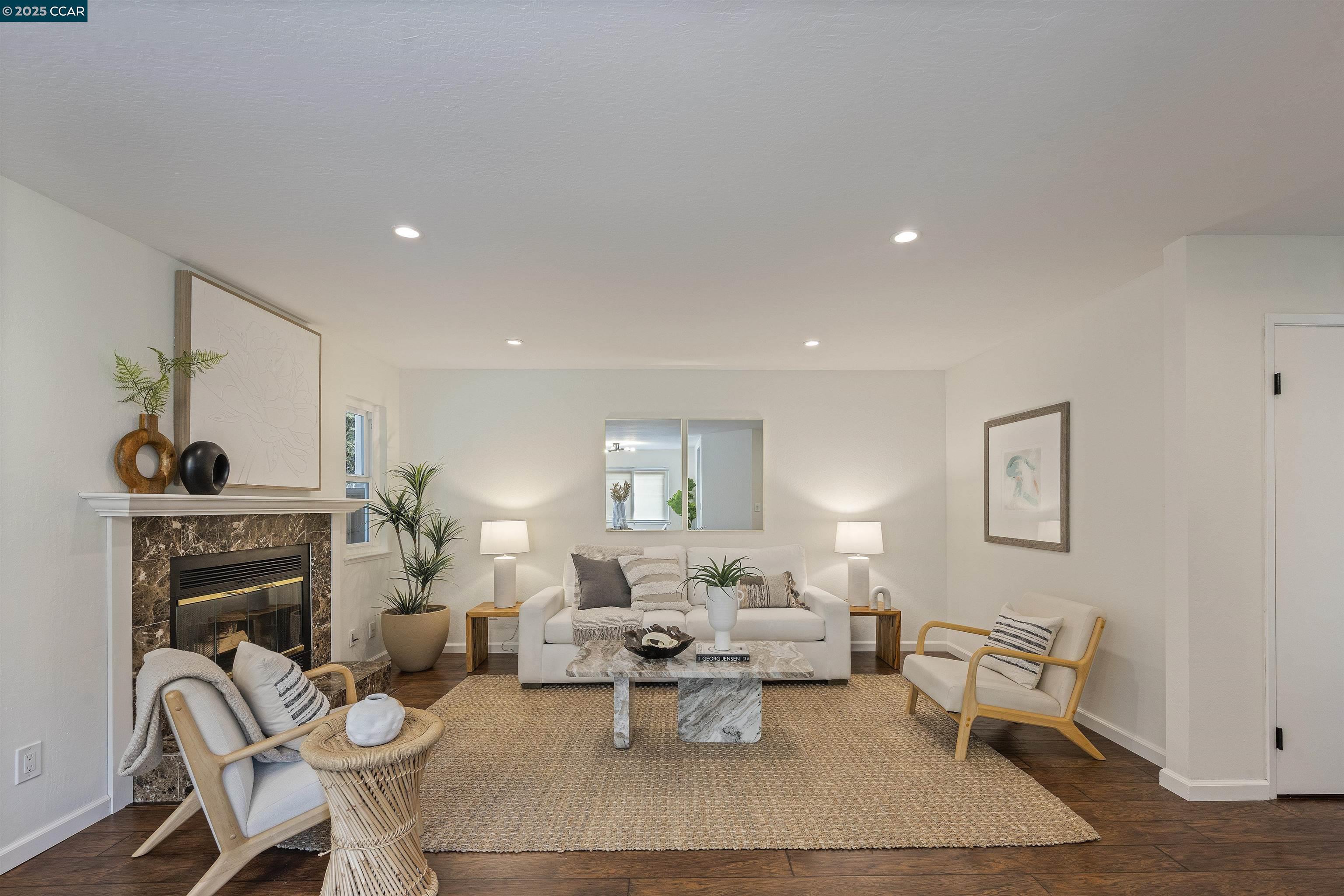 a living room with furniture and a fireplace