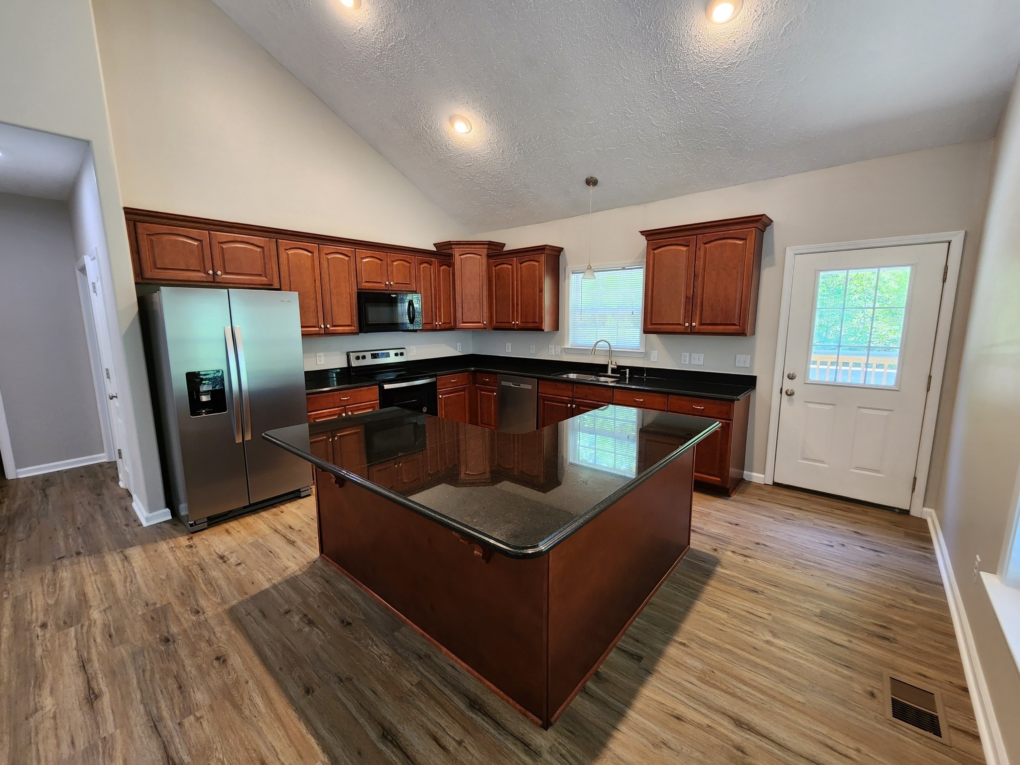 1415 Williamson Road, Unit B Goodlettsville, TN 37072 - Photo 4 of 18 a kitchen with stainless steel appliances granite countertop a sink and a refrigerator