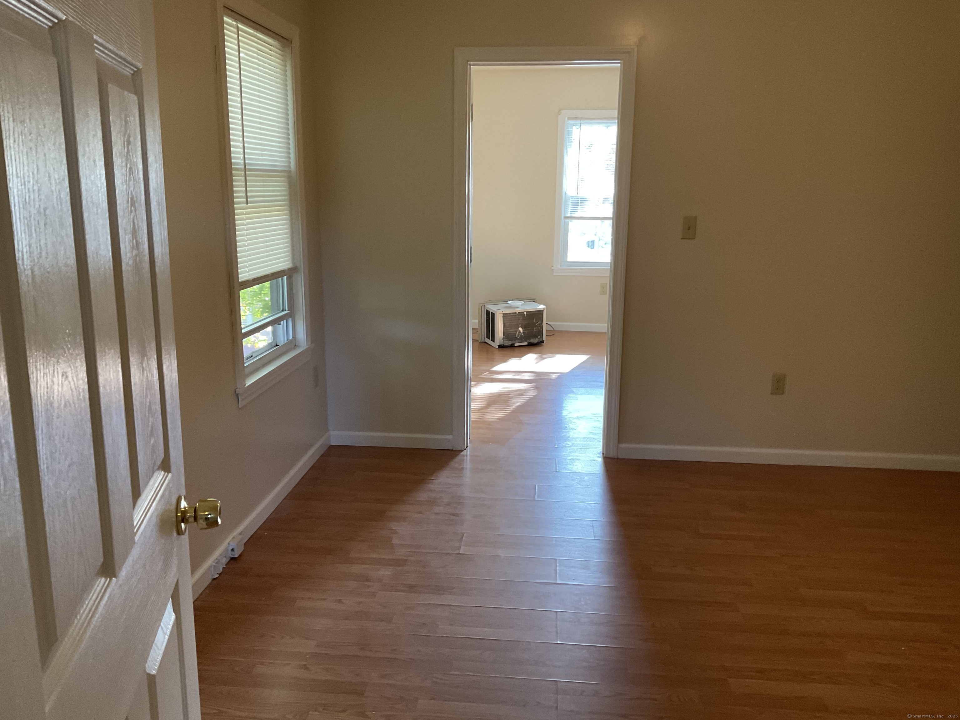 22 Oak Street Naugatuck, CT 06770 - Photo 2 of 7 a view of hallway with livingroom and wooden floor